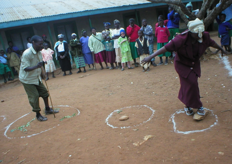 People standing in semi-circle watching a man and a woman role playing