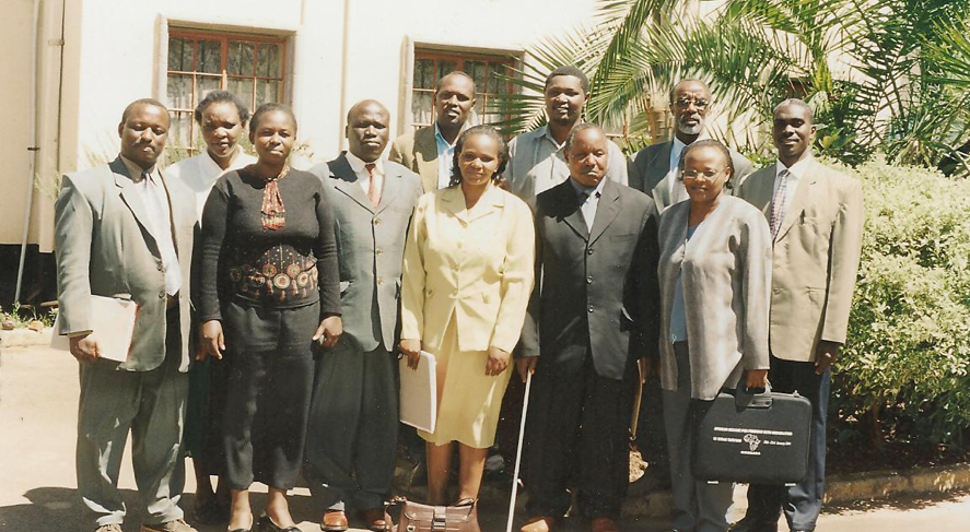 A group of well dressed adults posing for a picture